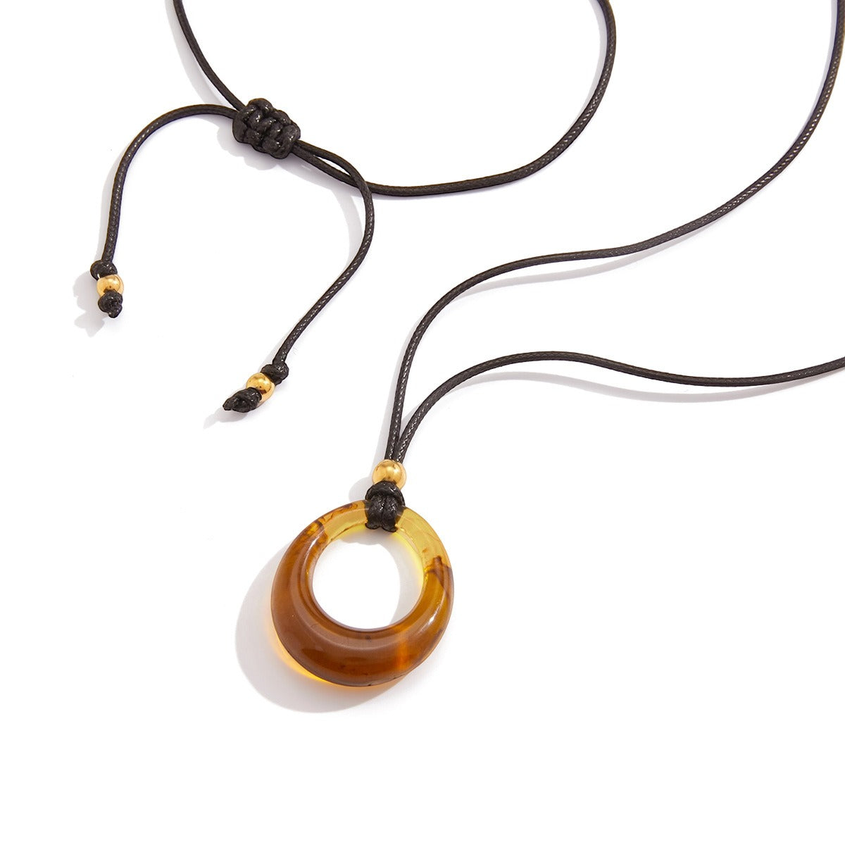 Amber-colored resin long necklace with a black cord.