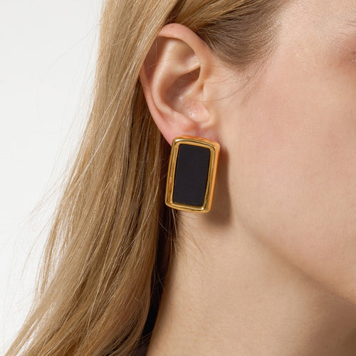 18K gold, black acrylic, and titanium steel stud earrings.