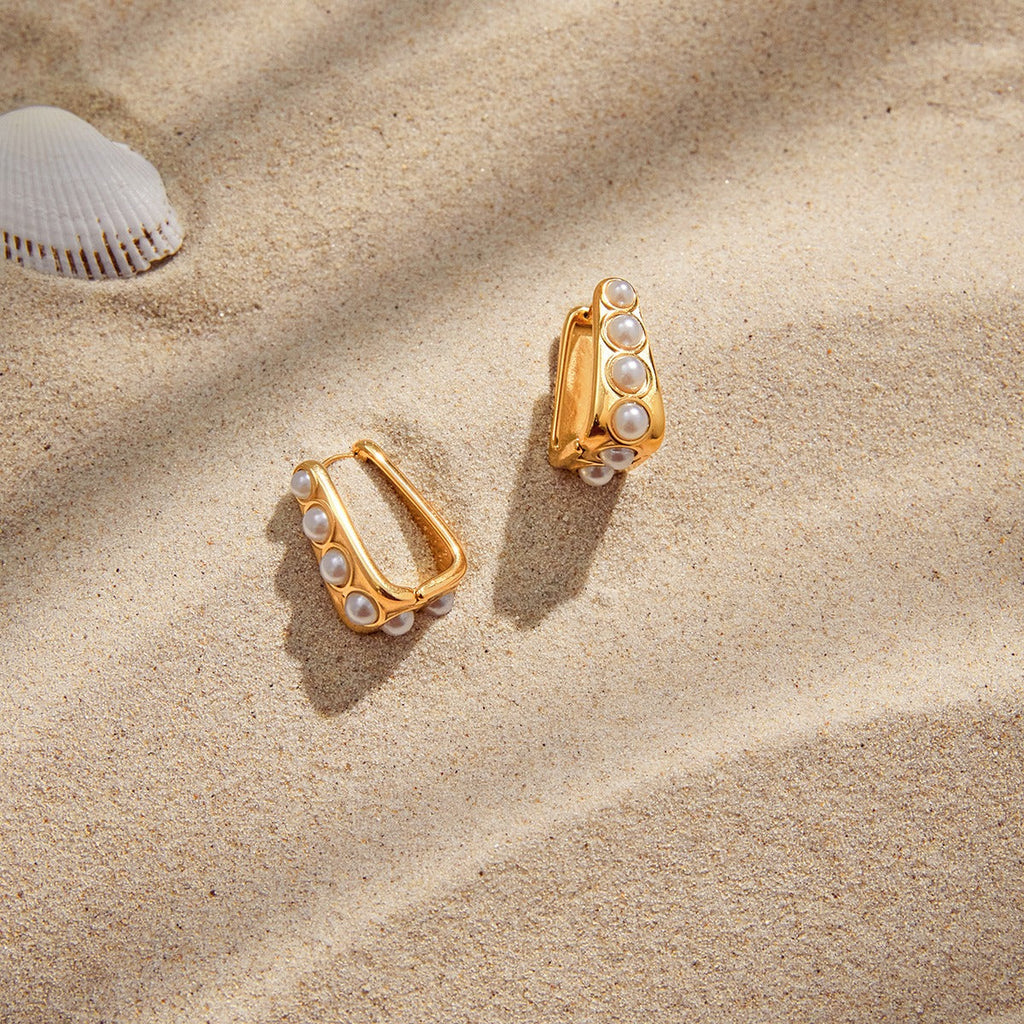 18K gold lightweight luxury earrings with embedded pearls.